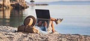Women working from the beach on computer
